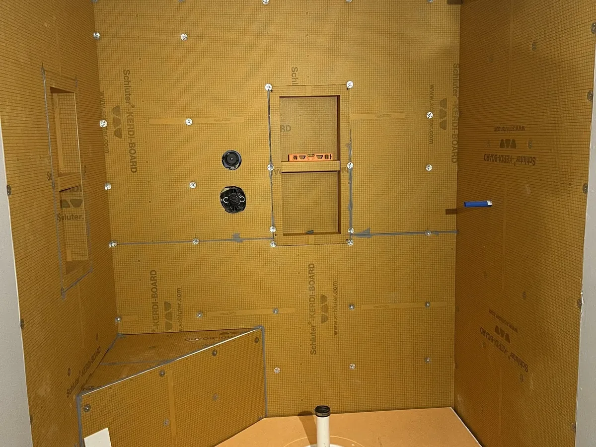Shower enclosure with waterproofing board and a built in bench before tile is set