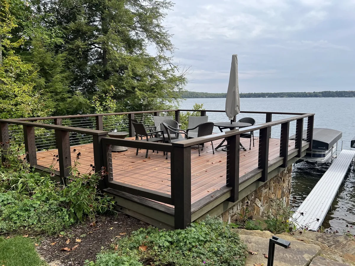 Wood deck built at the water's edge overlooking a lake and boat dock